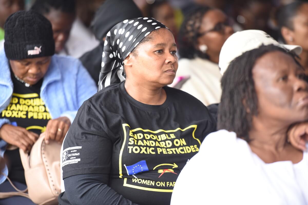 An activist listening attentively to the proceedings of the summit