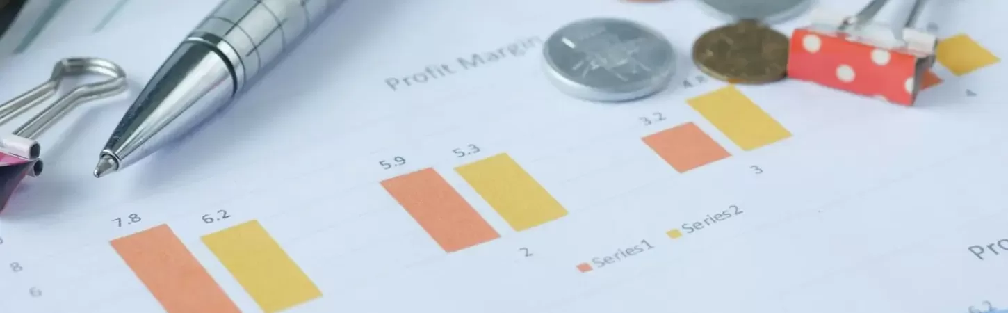 Financial graph, calculator and pen on table title=